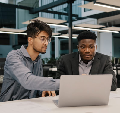 two men looking at the laptop
