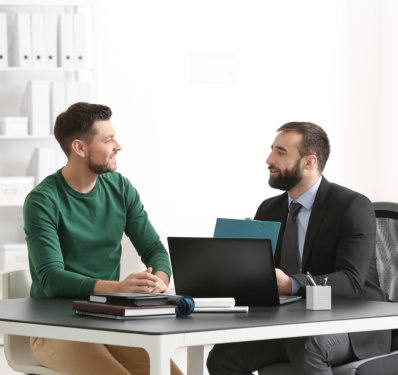 two men smiling while having a conversation