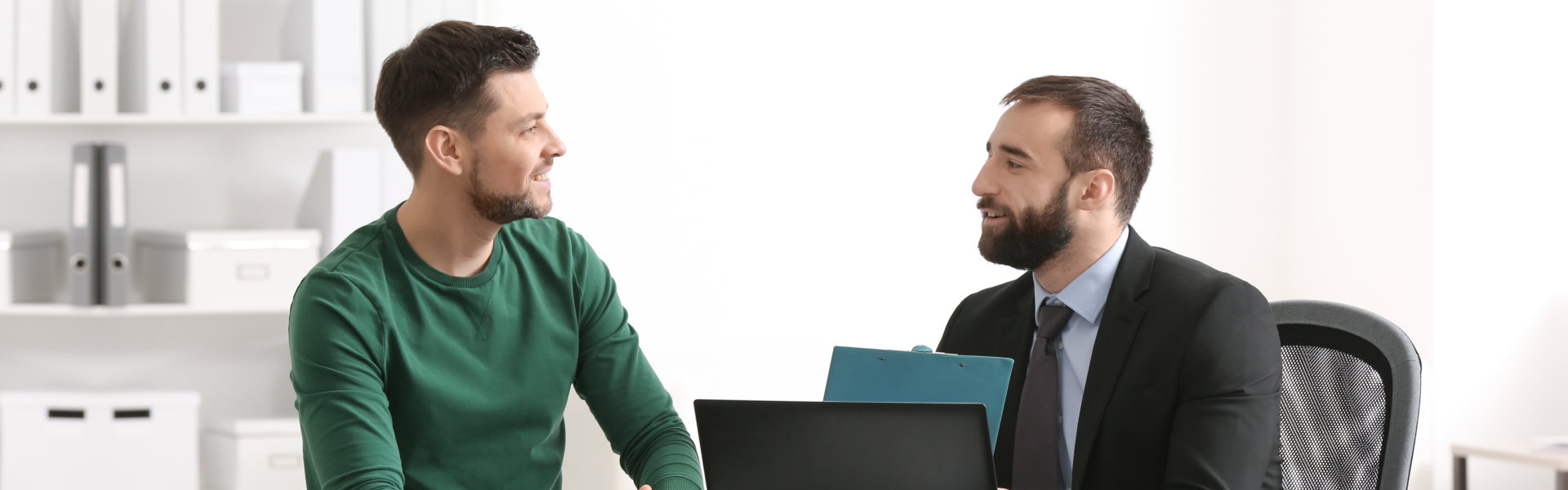 two men smiling while having a conversation